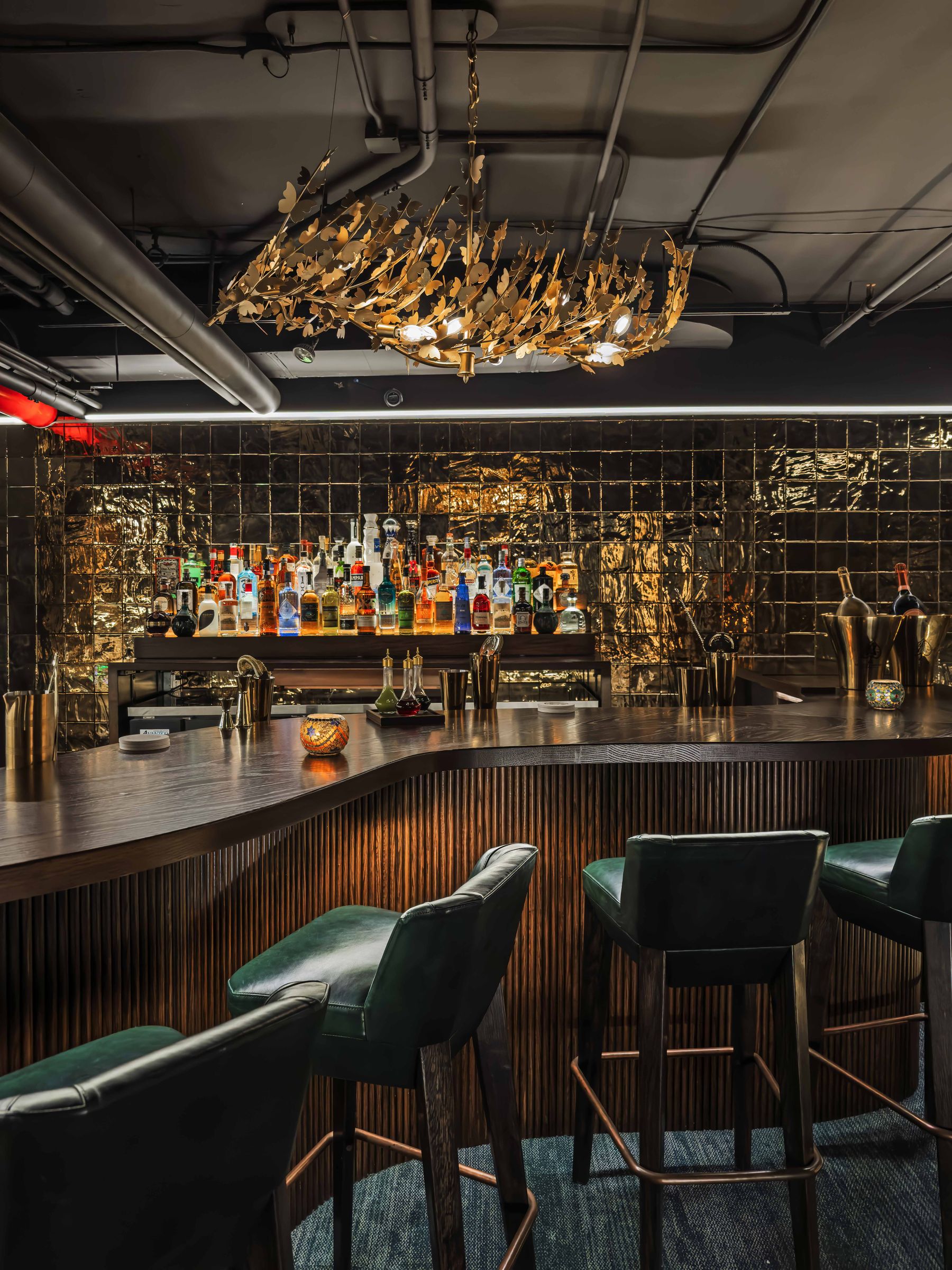 The fluted bar and its twelve stools in the 65-seat lounge below East 17th Street