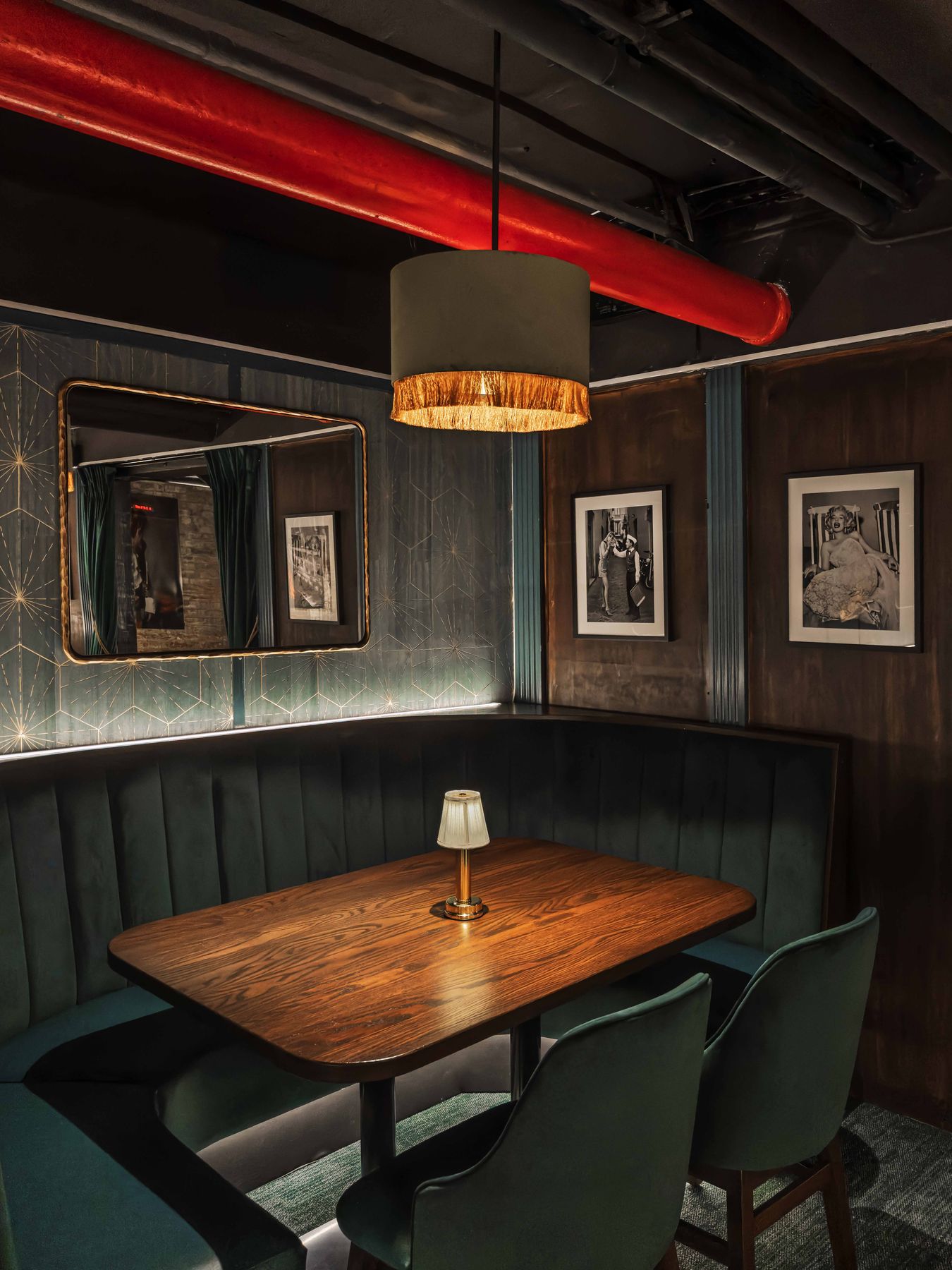 A green velvet booth in the 65-seat lounge below East 17th Street