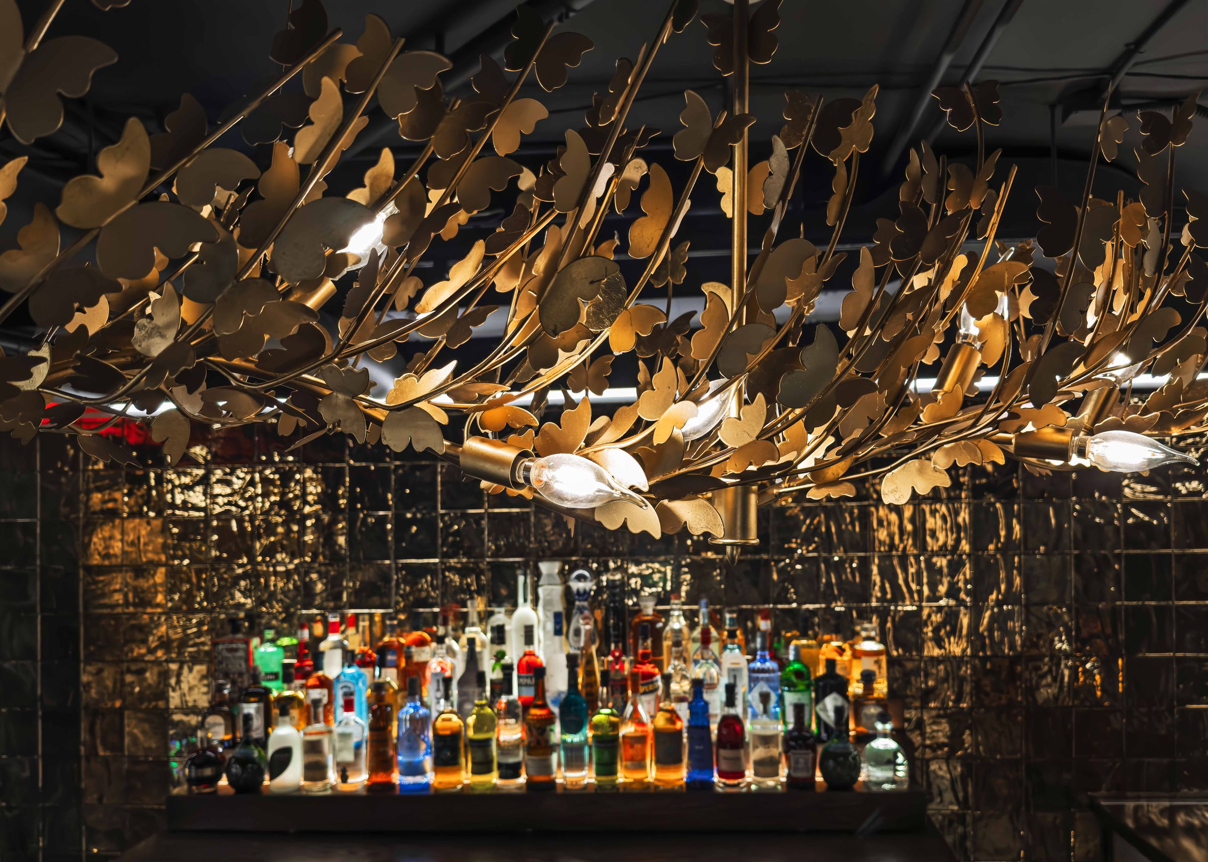 The chandelier above the gold-tiled bar in the 65-seat lounge below East 17th Street