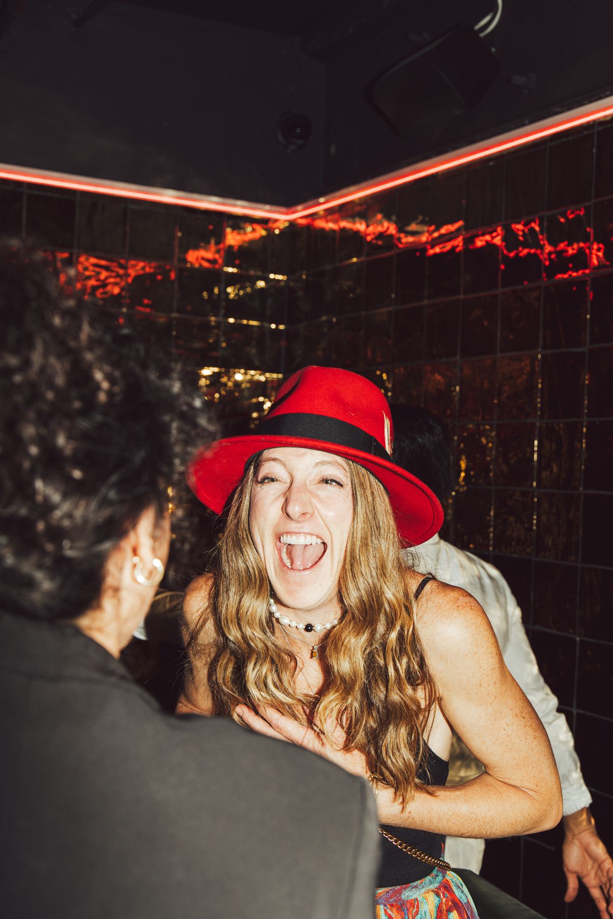 A guest in a red hat during an evening at Sub-Mission in Union Square, New York